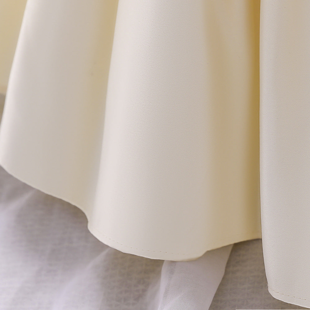 A cute baby girl wearing a solid color sleeveless dress with a bow patch, showcasing vibrant colors and a stylish design.