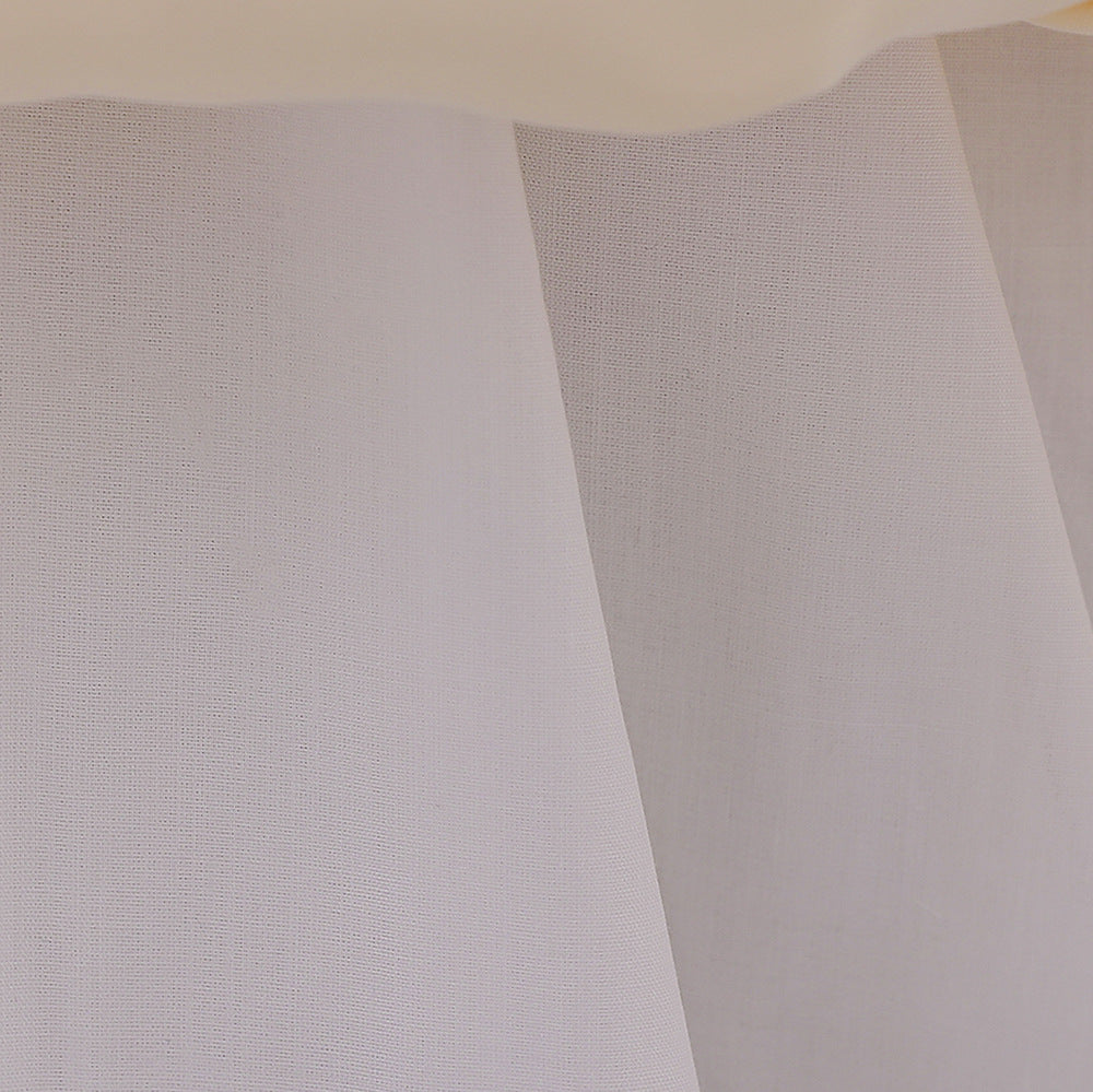 A cute baby girl wearing a solid color sleeveless dress with a bow patch, showcasing vibrant colors and a stylish design.