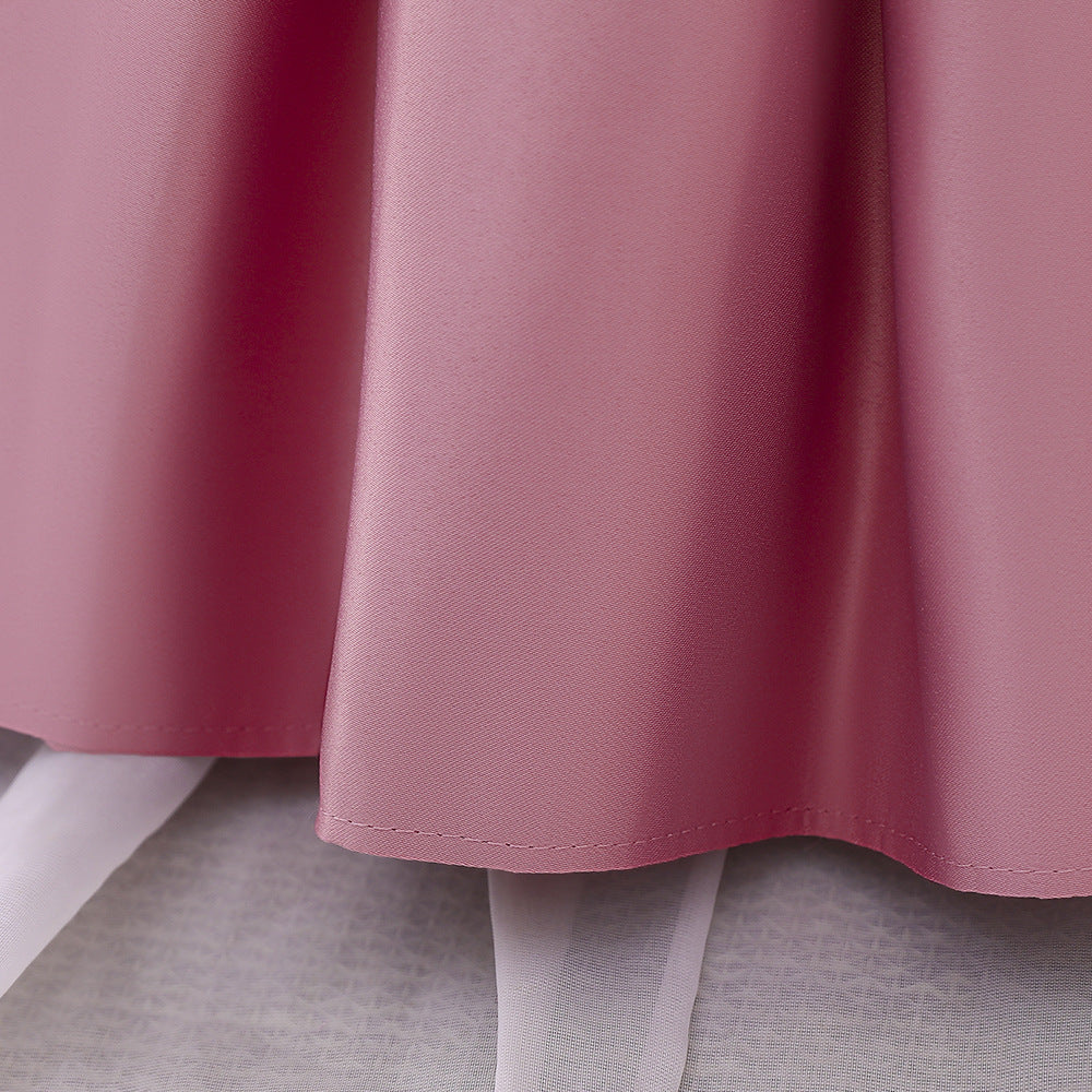 A cute baby girl wearing a solid color sleeveless dress with a bow patch, showcasing vibrant colors and a stylish design.