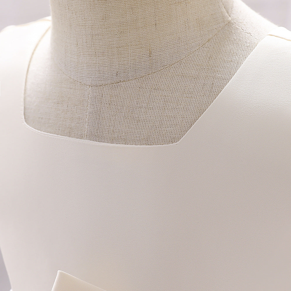 A cute baby girl wearing a solid color sleeveless dress with a bow patch, showcasing vibrant colors and a stylish design.