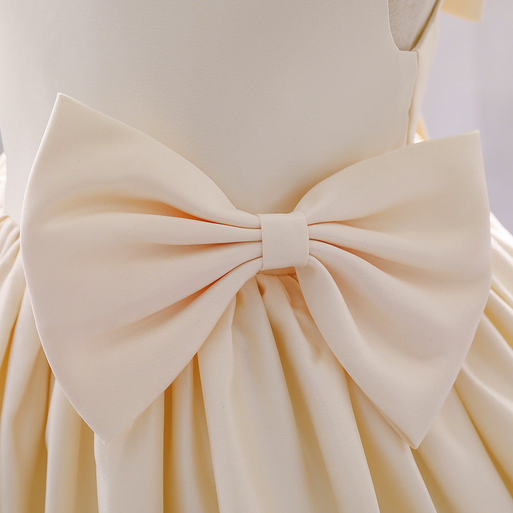 A cute baby girl wearing a solid color sleeveless dress with a bow patch, showcasing vibrant colors and a stylish design.