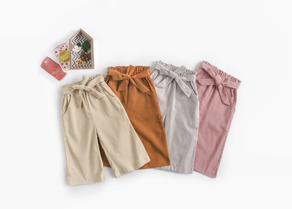 Baby girl corduroy nine-point wide leg pants with bow tie design in solid colors.