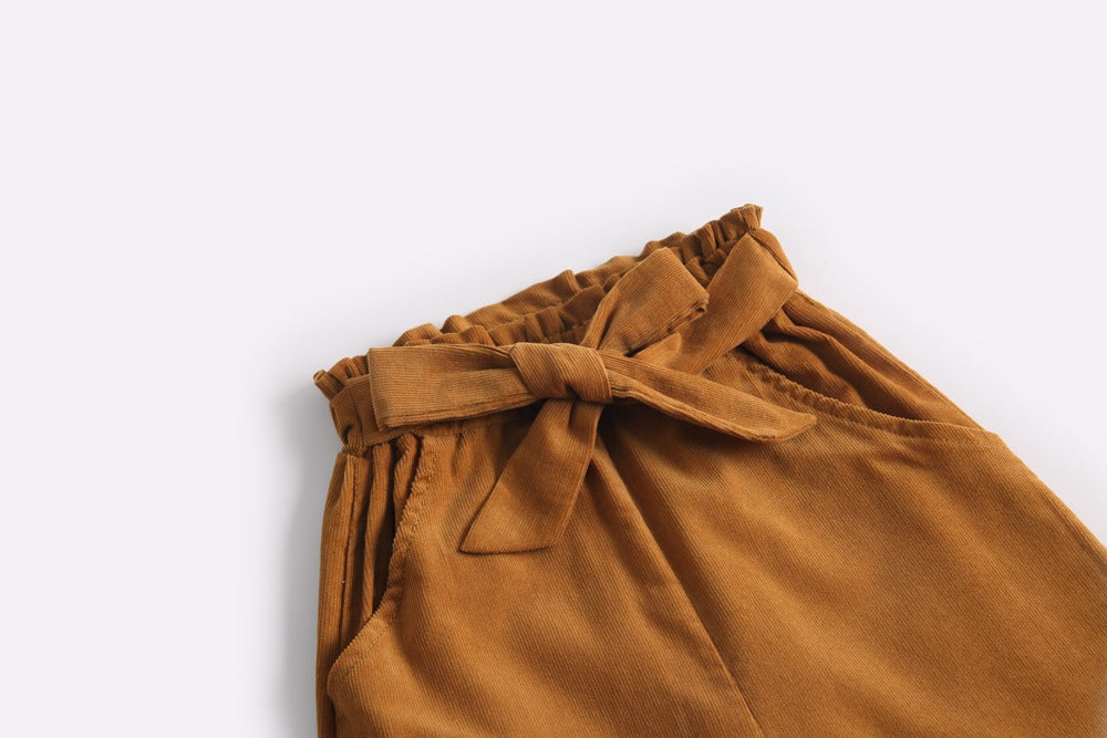 Baby girl corduroy nine-point wide leg pants with bow tie design in solid colors.