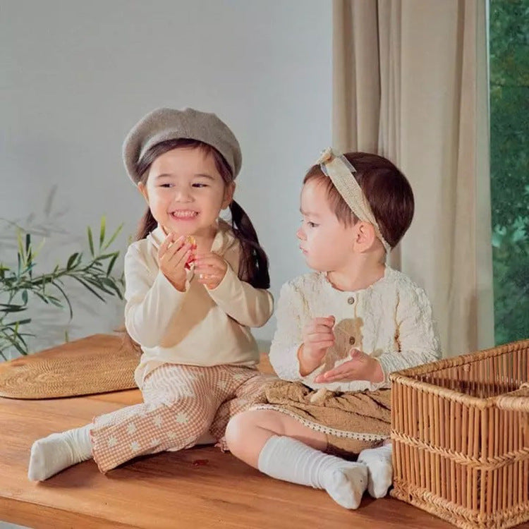 Baby girl long sleeve pullover top with solid color and bow tie design, available in white and coffee, made from soft cotton material.