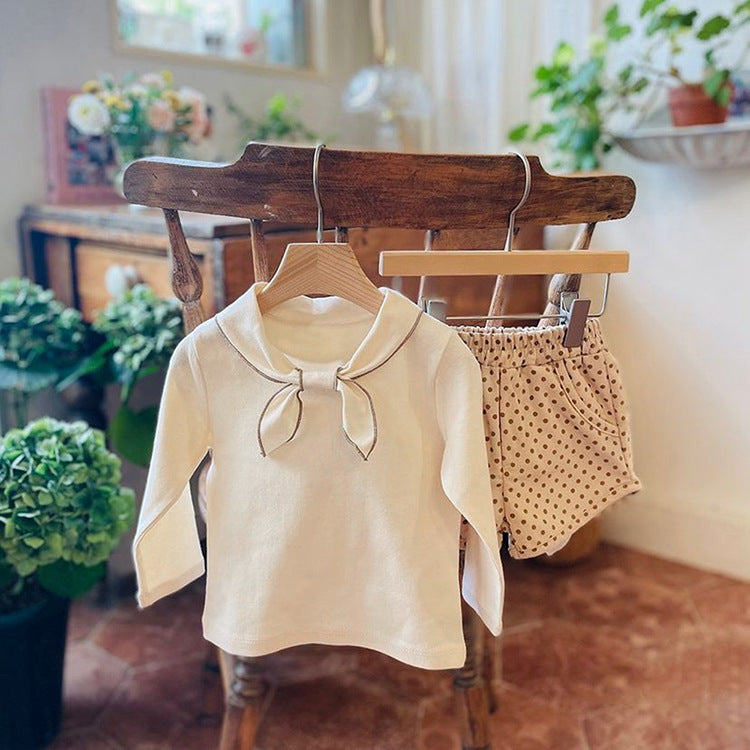 Baby girl long sleeve pullover top with solid color and bow tie design, available in white and coffee, made from soft cotton material.