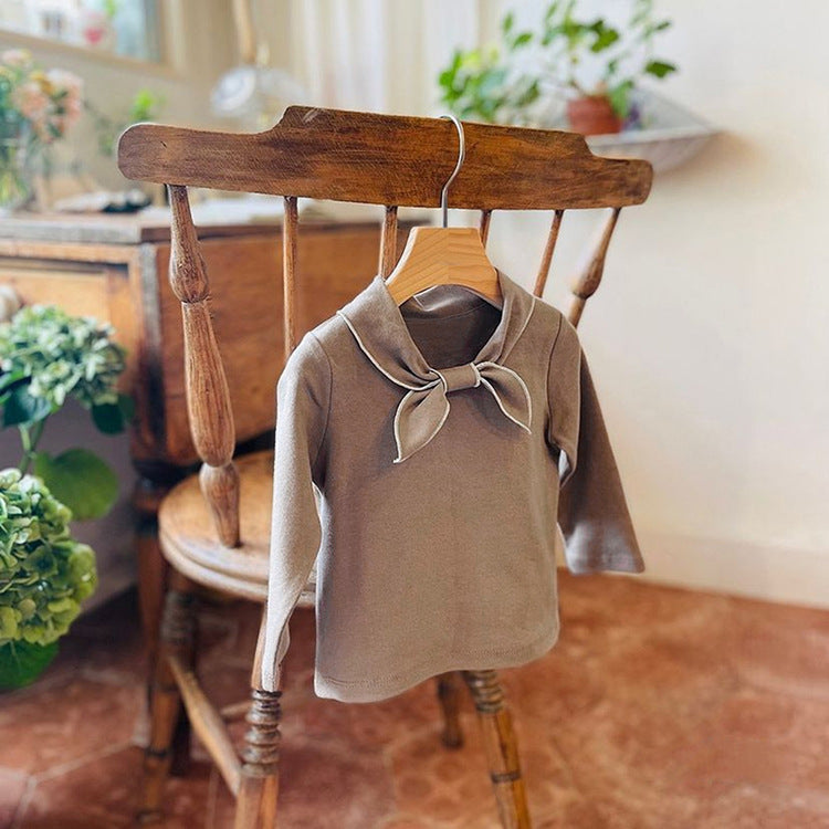 Baby girl long sleeve pullover top with solid color and bow tie design, available in white and coffee, made from soft cotton material.