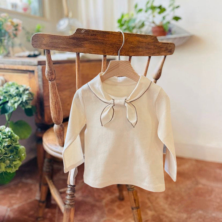 Baby girl long sleeve pullover top with solid color and bow tie design, available in white and coffee, made from soft cotton material.