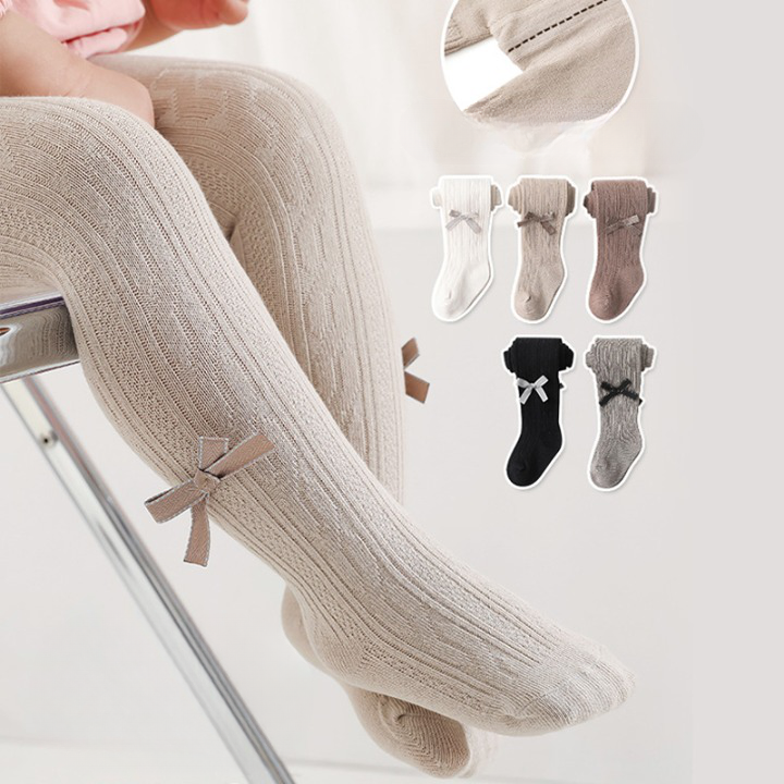 A pair of Baby Girl Solid Color Covered Leggings in various colors, showcasing their soft cotton material and elastic waistband.