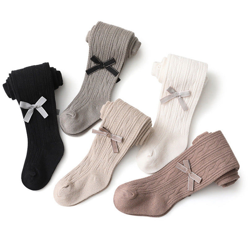 A pair of Baby Girl Solid Color Covered Leggings in various colors, showcasing their soft cotton material and elastic waistband.