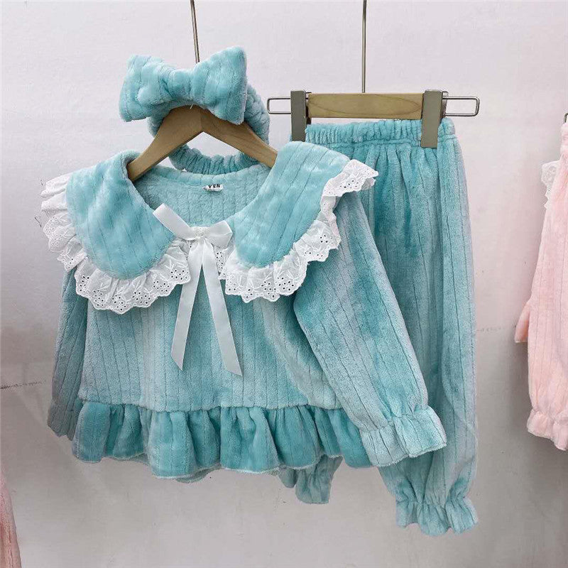 Baby girl wearing a solid color doll neck fleece tracksuit in pink, featuring thickened tops and trousers, perfect for winter.