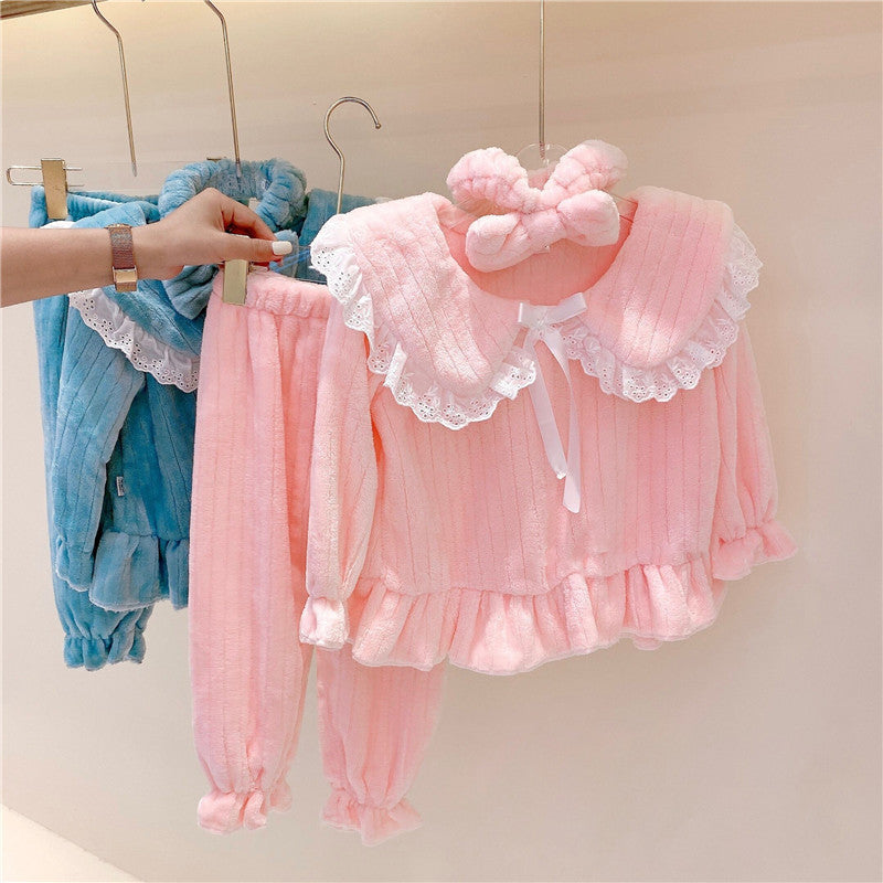 Baby girl wearing a solid color doll neck fleece tracksuit in pink, featuring thickened tops and trousers, perfect for winter.