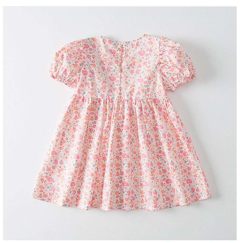 A beautiful baby girl dress featuring a solid color, embroidered design, and classic doll-neckline, available in pink and green.