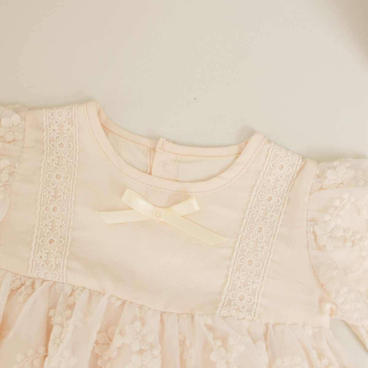 Baby girl onesie featuring solid color with floral embroidery and mesh overlay, perfect for spring and autumn wear.