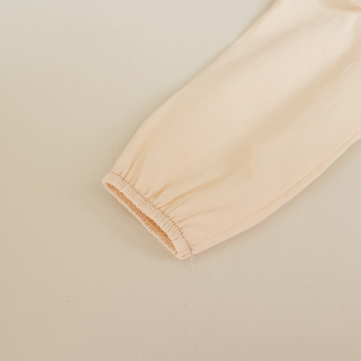 Baby girl onesie featuring solid color with floral embroidery and mesh overlay, perfect for spring and autumn wear.