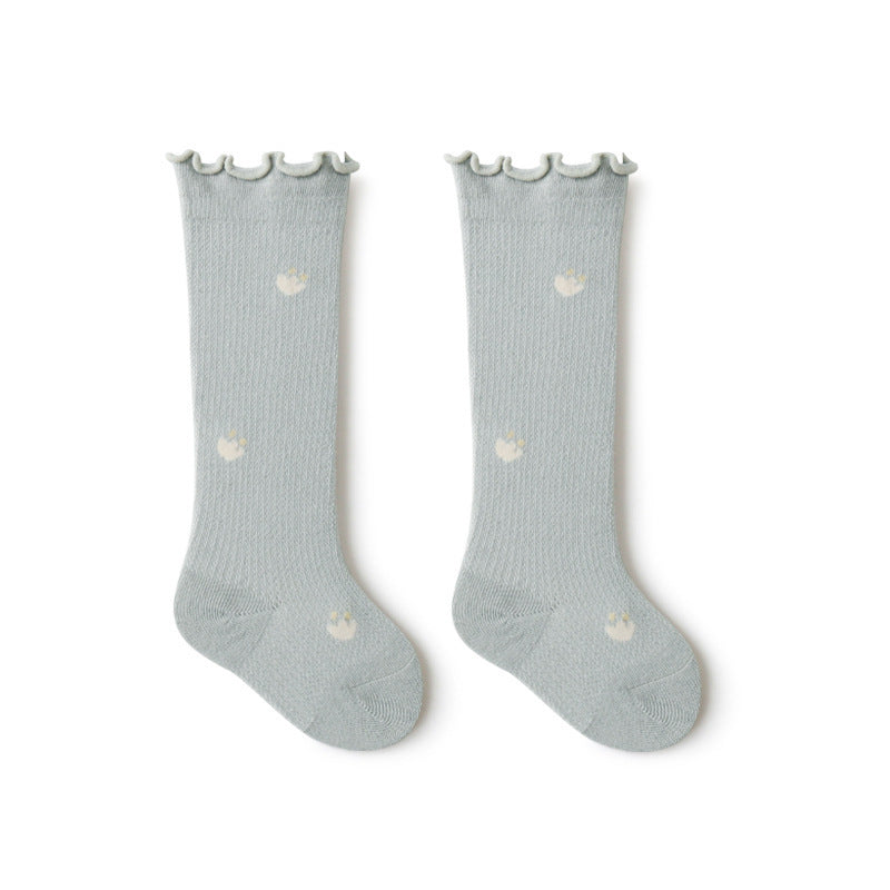 Baby girl knee socks with floral embroidery in various solid colors, made from breathable cotton.