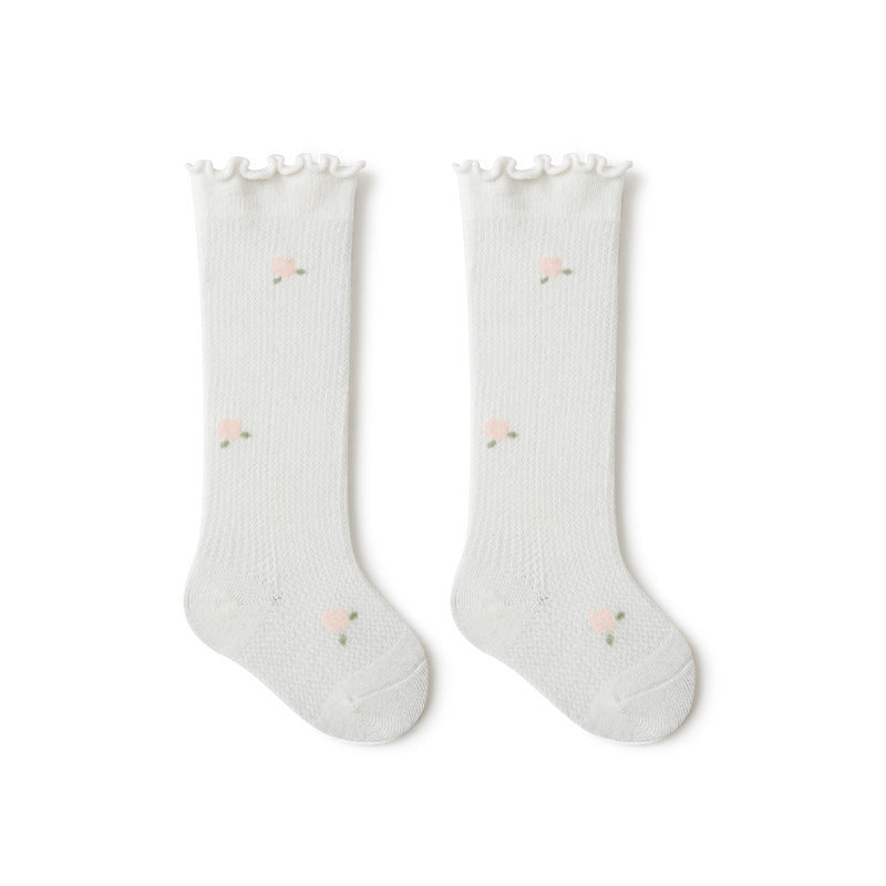 Baby girl knee socks with floral embroidery in various solid colors, made from breathable cotton.