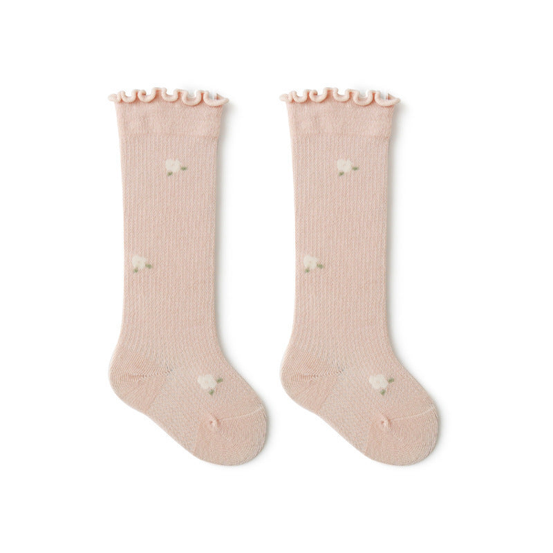 Baby girl knee socks with floral embroidery in various solid colors, made from breathable cotton.