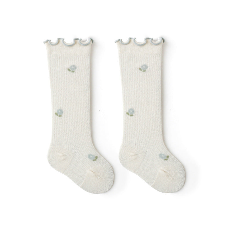 Baby girl knee socks with floral embroidery in various solid colors, made from breathable cotton.
