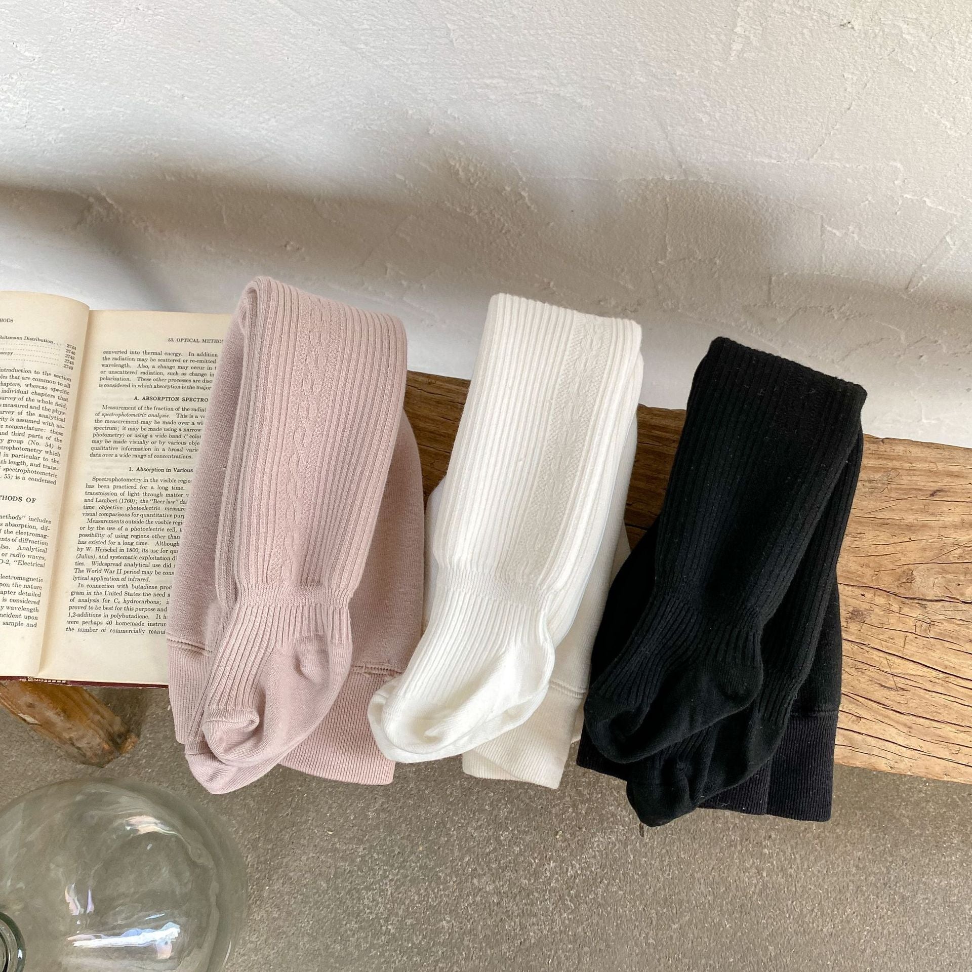 Baby girl solid color foot pantyhose with plush velvet lining, available in white, black, and pink, designed for warmth and comfort.