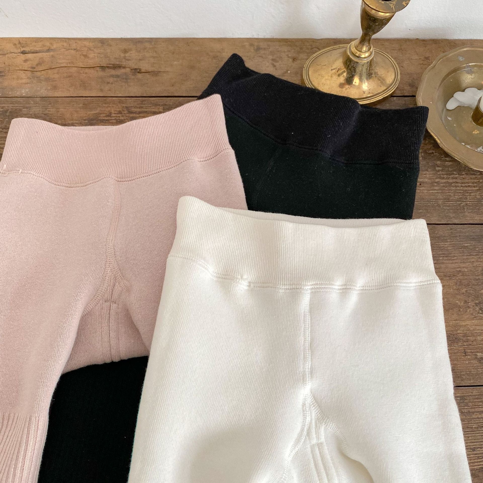 Baby girl solid color foot pantyhose with plush velvet lining, available in white, black, and pink, designed for warmth and comfort.