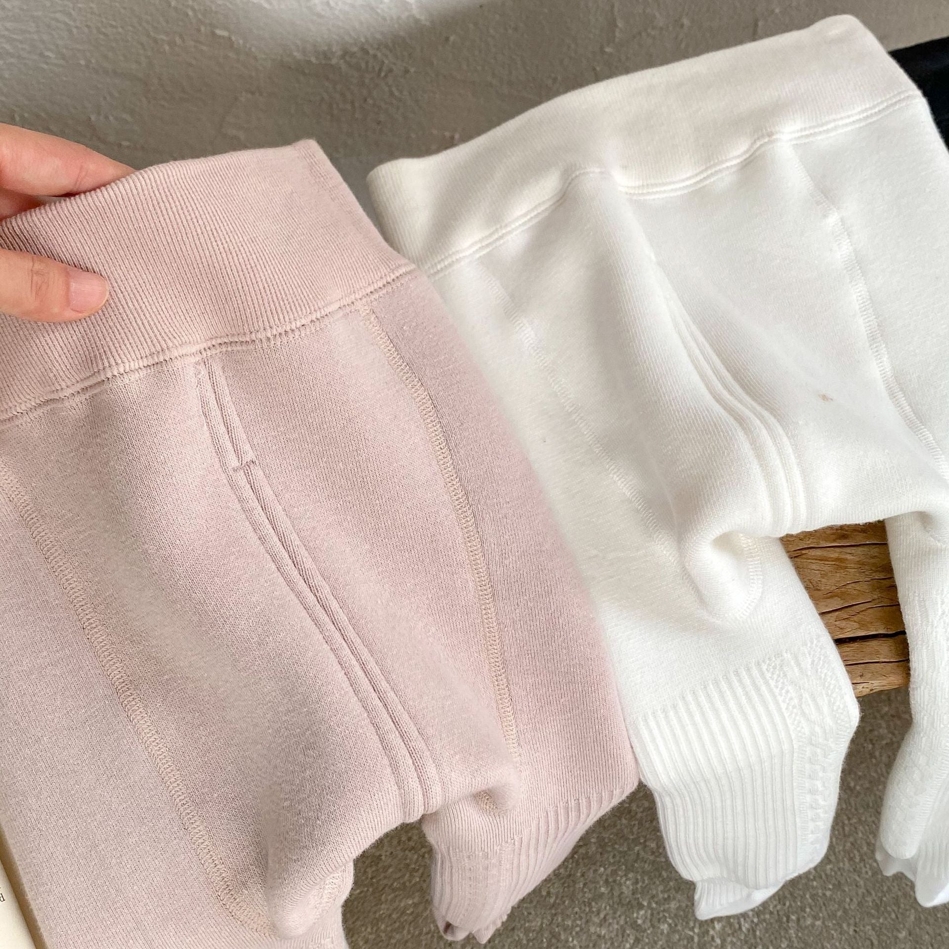 Baby girl solid color foot pantyhose with plush velvet lining, available in white, black, and pink, designed for warmth and comfort.