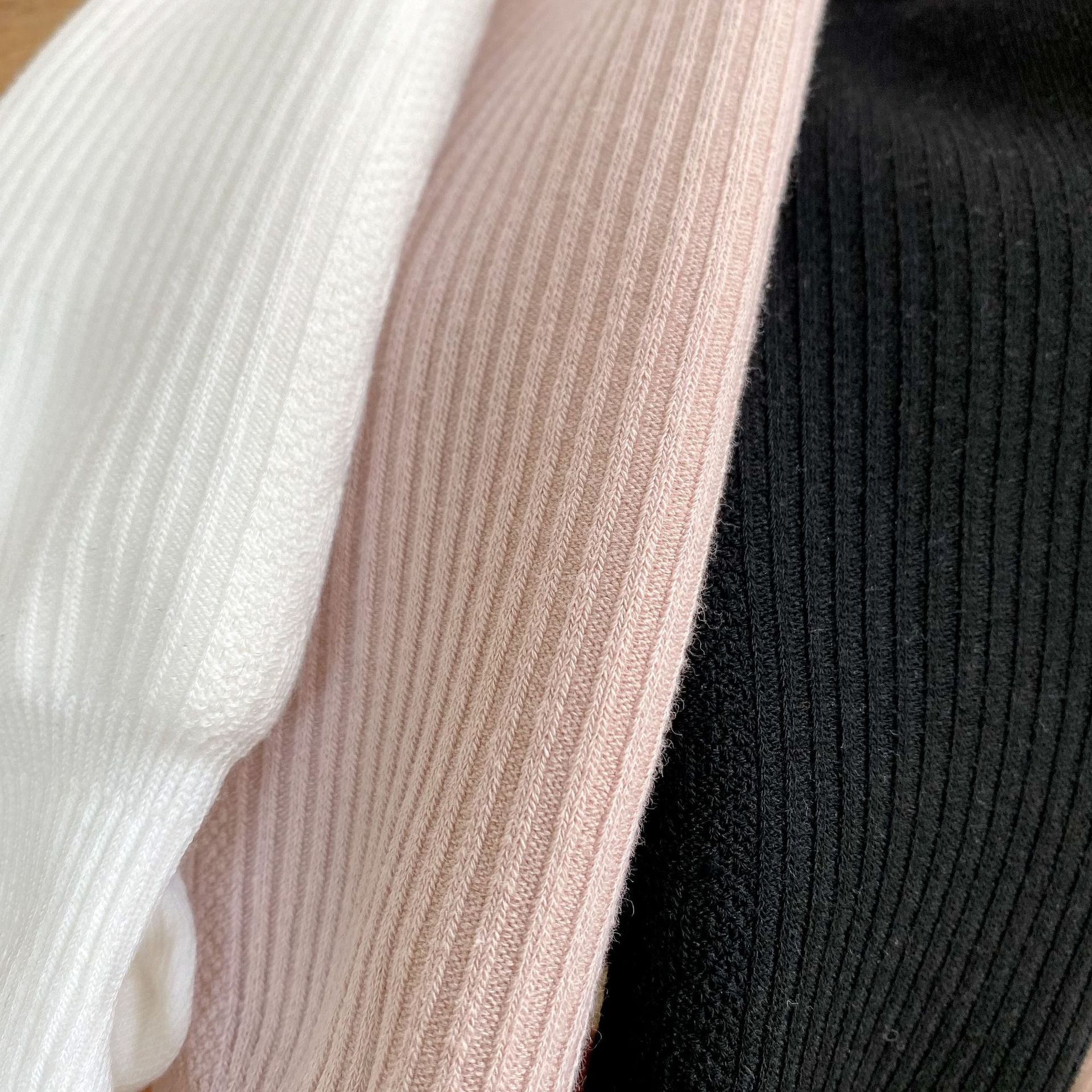 Baby girl solid color foot pantyhose with plush velvet lining, available in white, black, and pink, designed for warmth and comfort.