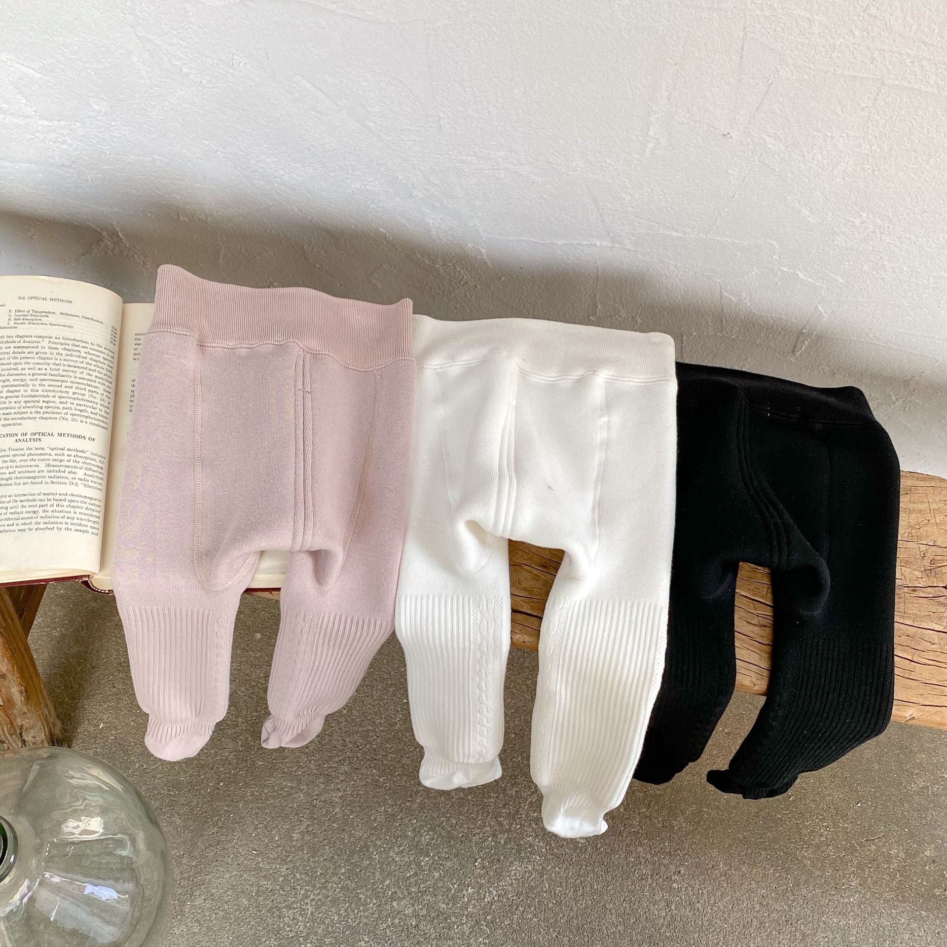 Baby girl solid color foot pantyhose with plush velvet lining, available in white, black, and pink, designed for warmth and comfort.