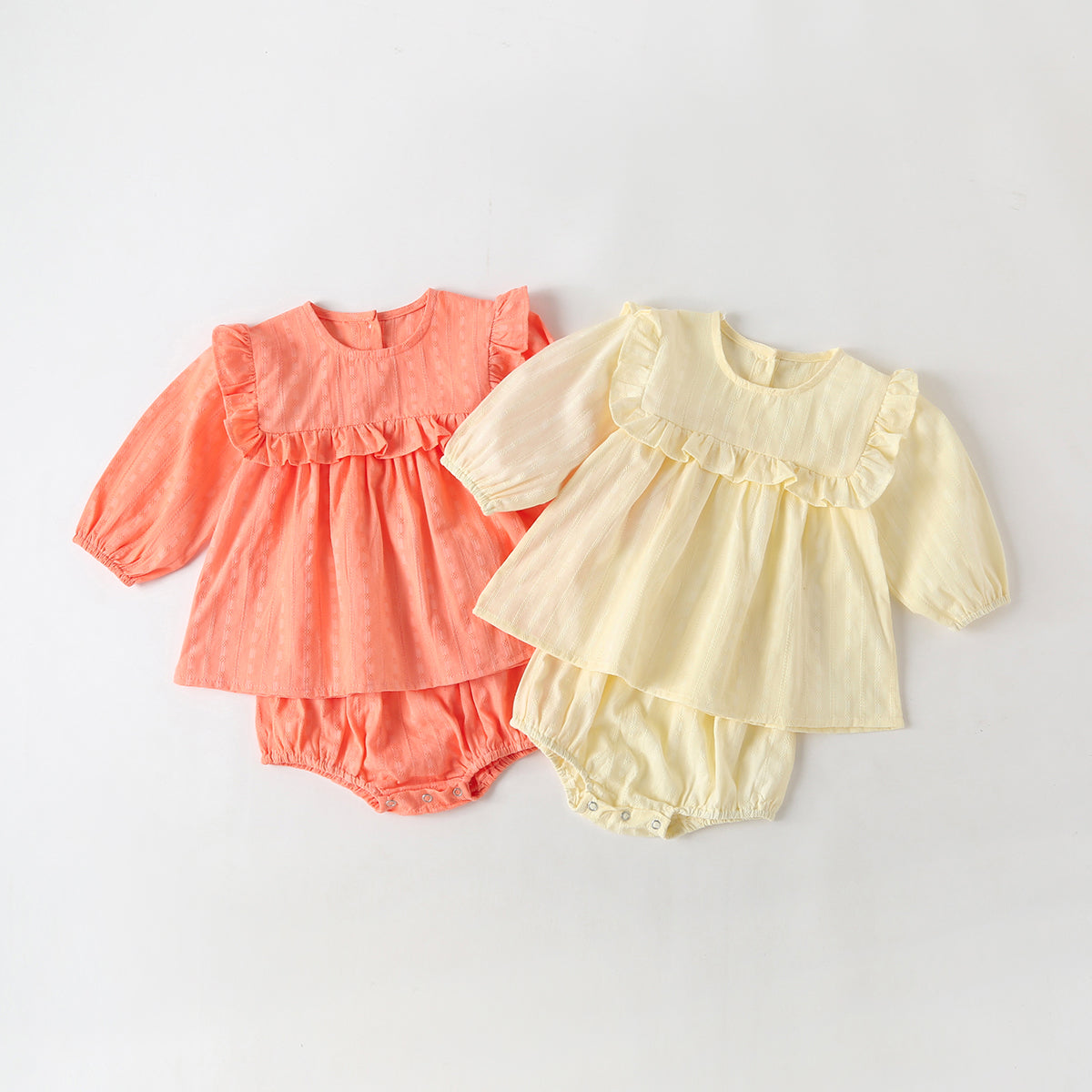 Baby girl outfit featuring solid color long-sleeve tops with frill trim and triangle shorts in pink and beige.