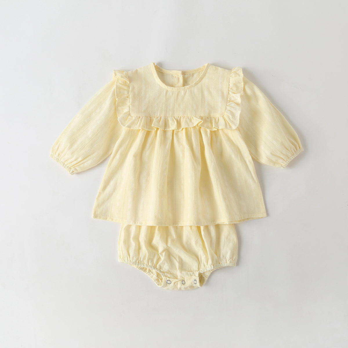 Baby girl outfit featuring solid color long-sleeve tops with frill trim and triangle shorts in pink and beige.