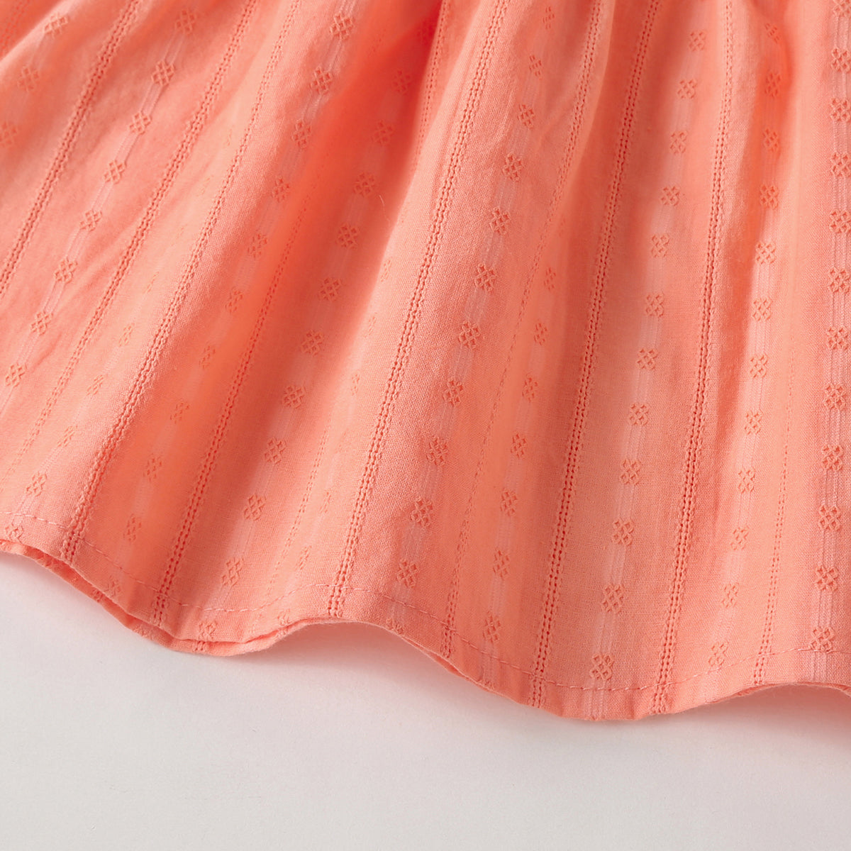 Baby girl outfit featuring solid color long-sleeve tops with frill trim and triangle shorts in pink and beige.