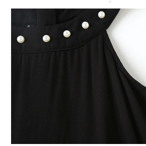 A stylish baby girl dress featuring a halter neck design and an irregular tiered hem in solid black color, perfect for summer occasions.