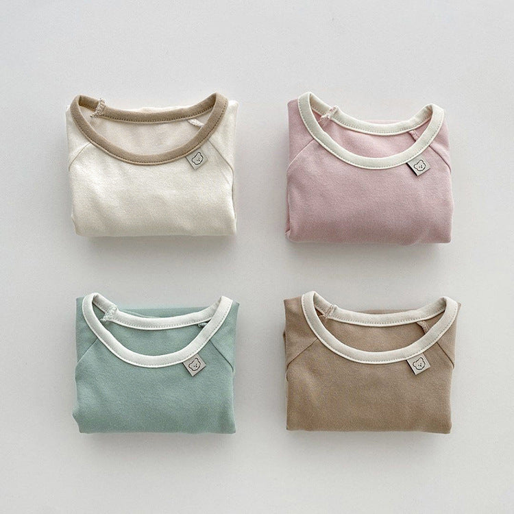 Baby girl bodysuit in solid pink and apricot colors, featuring long sleeves and soft cotton material, perfect for comfort and style.