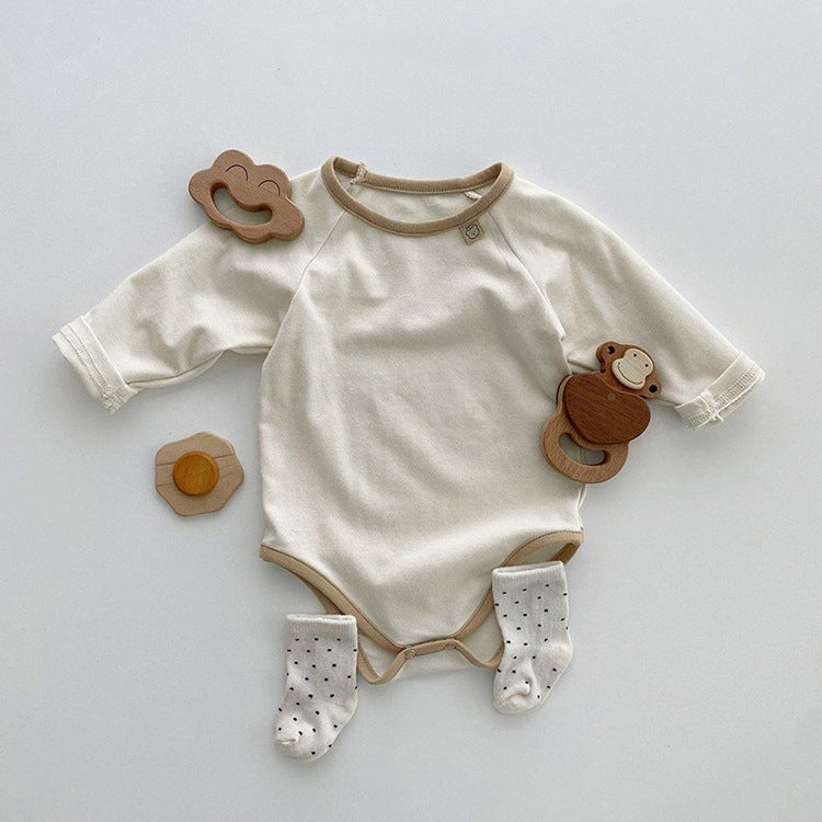 Baby girl bodysuit in solid pink and apricot colors, featuring long sleeves and soft cotton material, perfect for comfort and style.