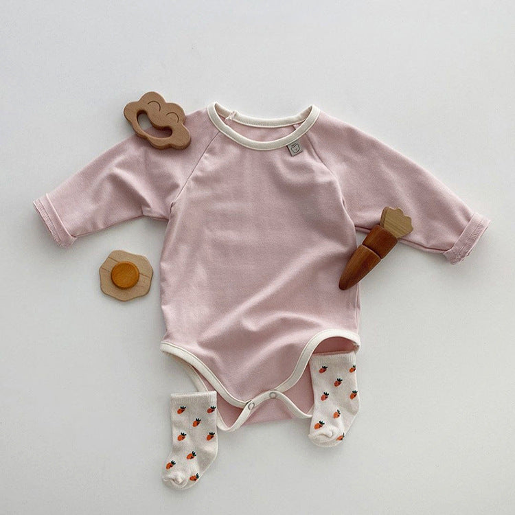 Baby girl bodysuit in solid pink and apricot colors, featuring long sleeves and soft cotton material, perfect for comfort and style.