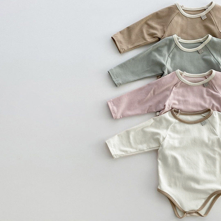 Baby girl bodysuit in solid pink and apricot colors, featuring long sleeves and soft cotton material, perfect for comfort and style.