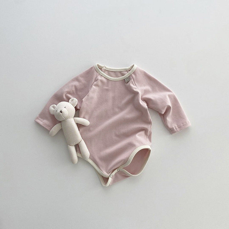 Baby girl bodysuit in solid pink and apricot colors, featuring long sleeves and soft cotton material, perfect for comfort and style.