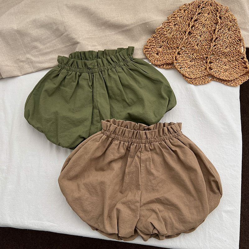 Baby girl solid color loose soft cotton shorts in green and brown, perfect for summer wear.
