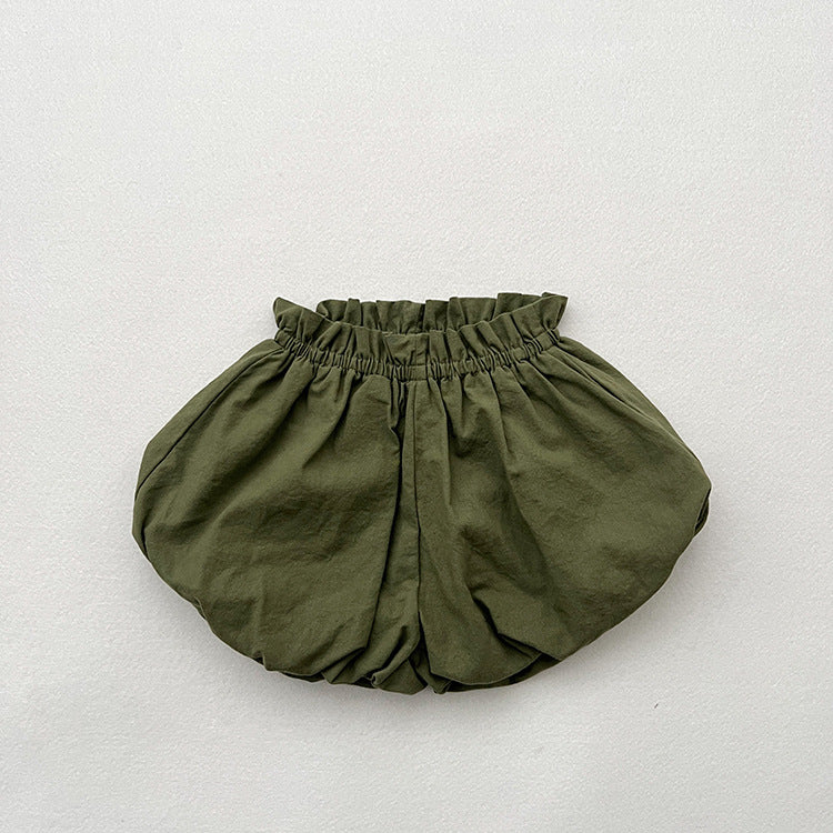 Baby girl solid color loose soft cotton shorts in green and brown, perfect for summer wear.