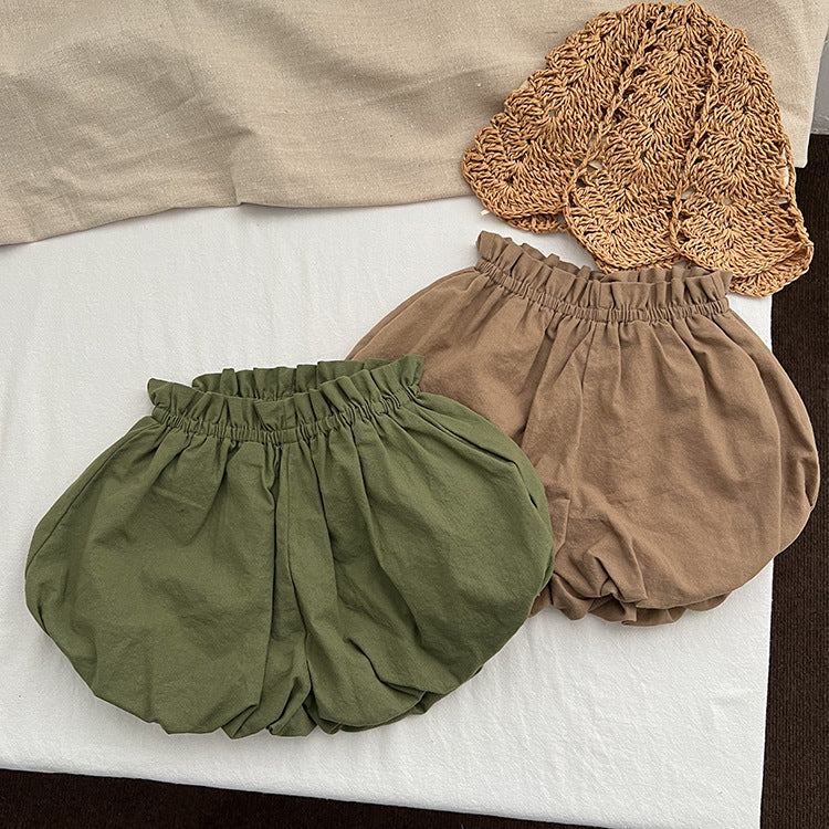 Baby girl solid color loose soft cotton shorts in green and brown, perfect for summer wear.