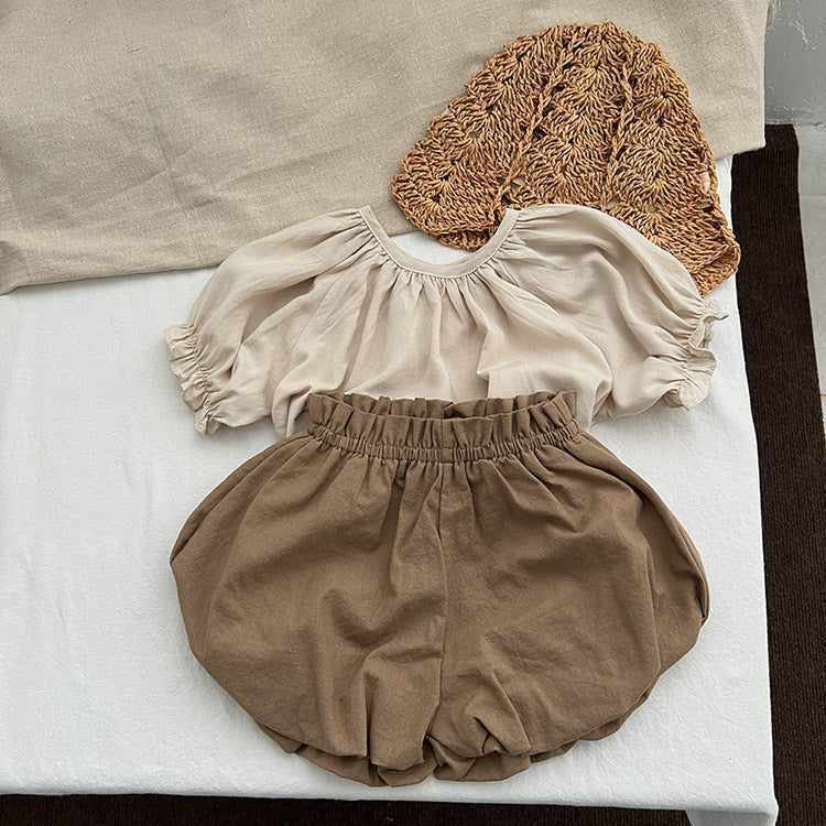 Baby girl solid color loose soft cotton shorts in green and brown, perfect for summer wear.