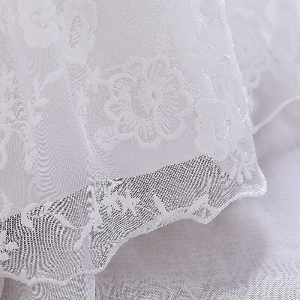 Baby girl dress with solid color mesh overlay and matching hat, perfect for formal occasions like baptisms and birthdays.