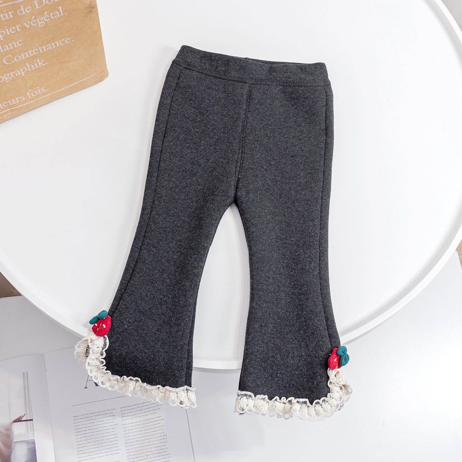 Baby girl fleece pants in solid color with mesh patches, available in black and grey, designed for warmth and comfort.