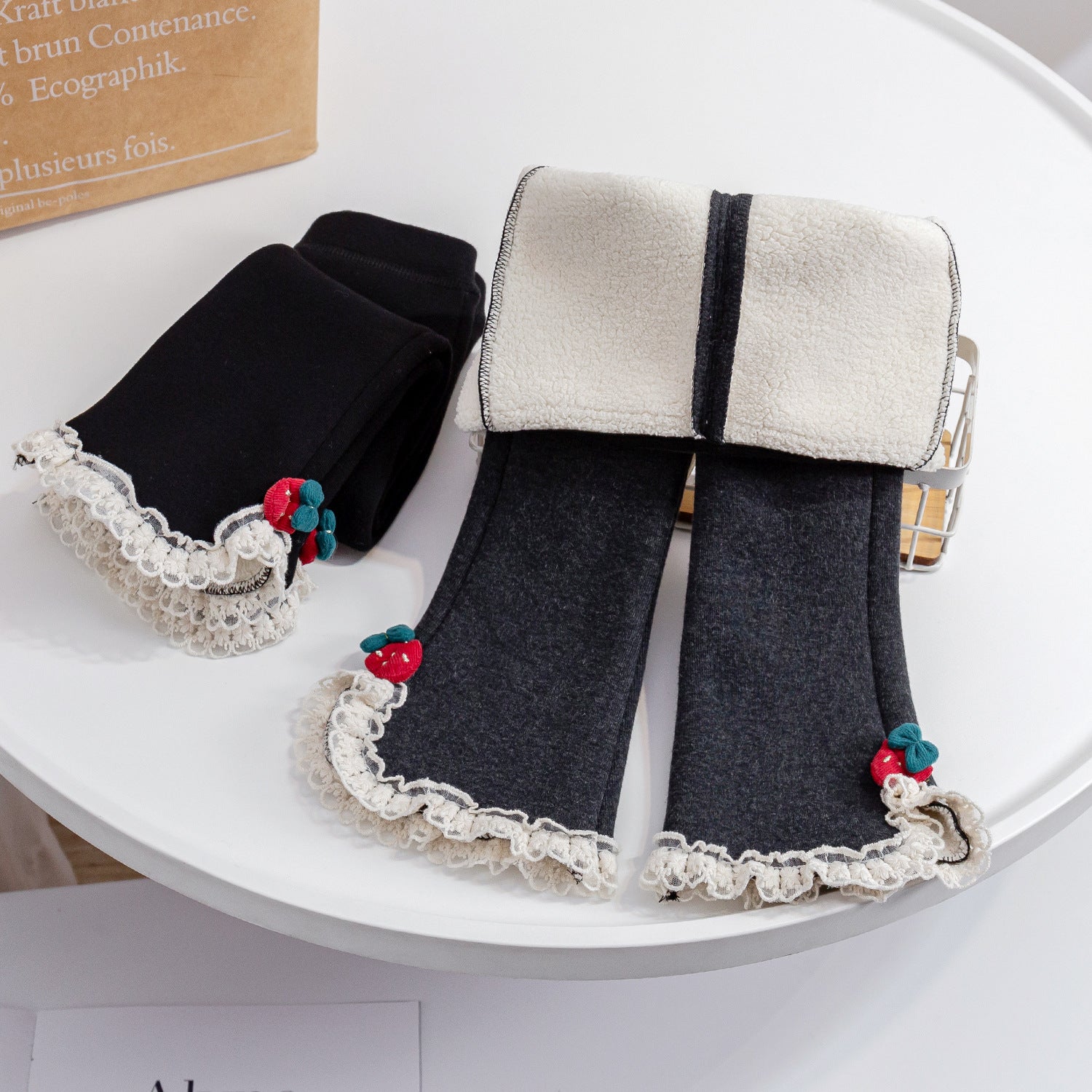 Baby girl fleece pants in solid color with mesh patches, available in black and grey, designed for warmth and comfort.