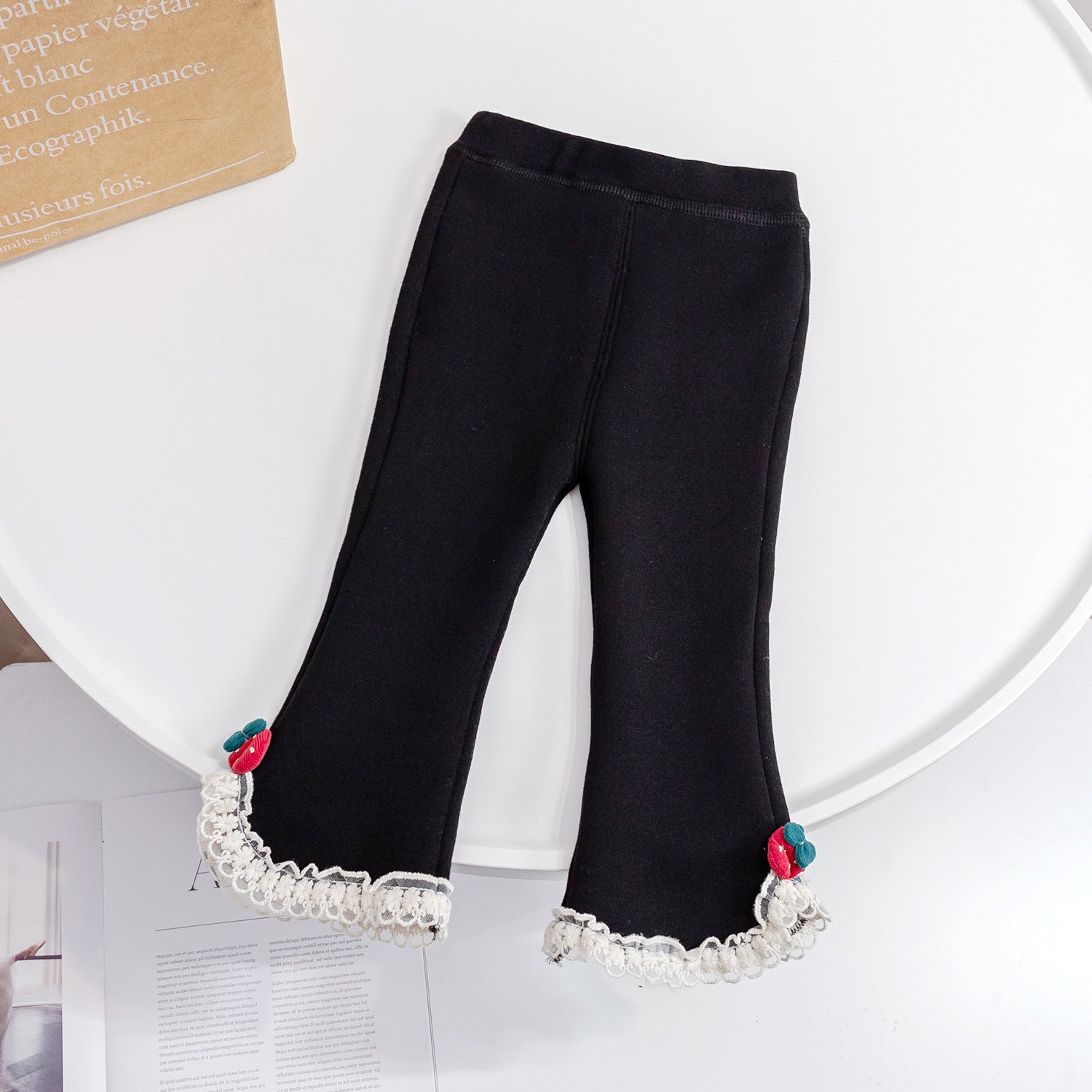 Baby girl fleece pants in solid color with mesh patches, available in black and grey, designed for warmth and comfort.