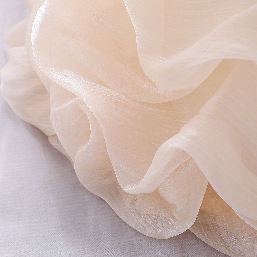 Baby girl wearing a solid color one shoulder tutu dress in white, perfect for formal occasions like baptisms.
