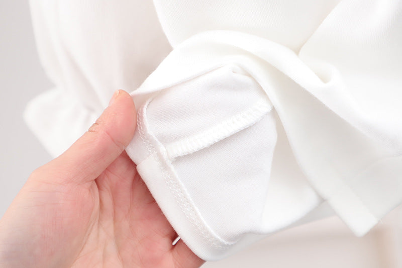 Baby girl solid color shirt with rabbit print and doll-neck collar, perfect for summer wear.