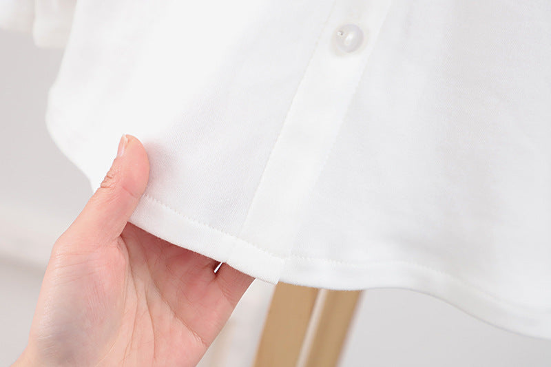 Baby girl solid color shirt with rabbit print and doll-neck collar, perfect for summer wear.