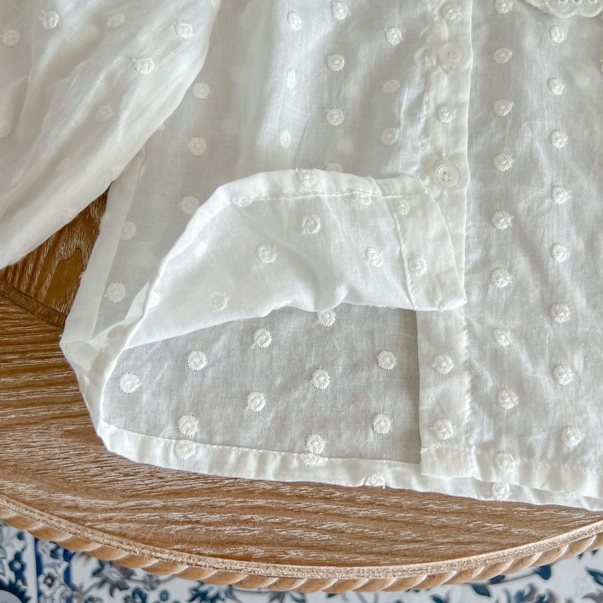 Baby girl wearing a solid color doll neck shirt and shorts set in white and green, showcasing a stylish and comfortable outfit.