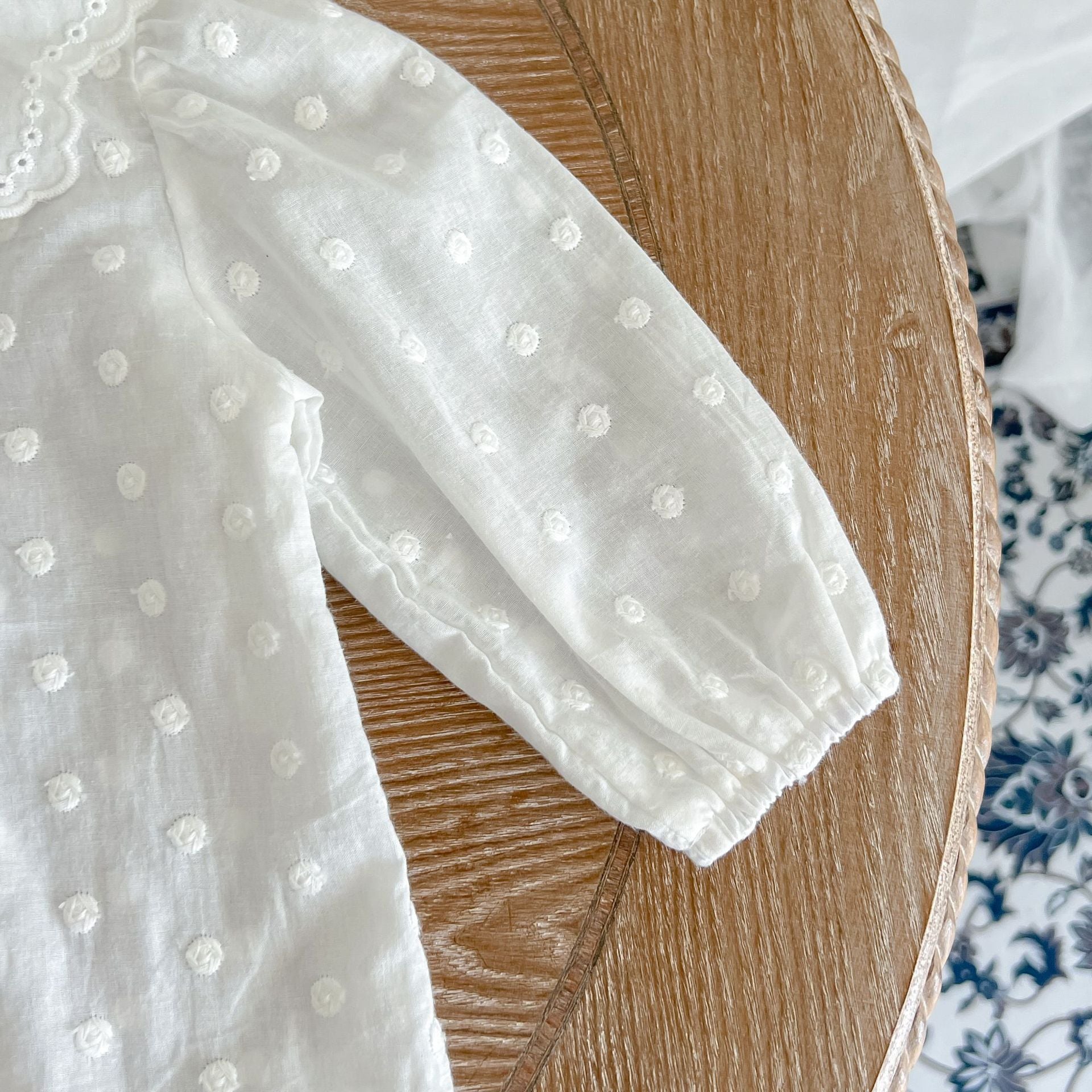 Baby girl wearing a solid color doll neck shirt and shorts set in white and green, showcasing a stylish and comfortable outfit.