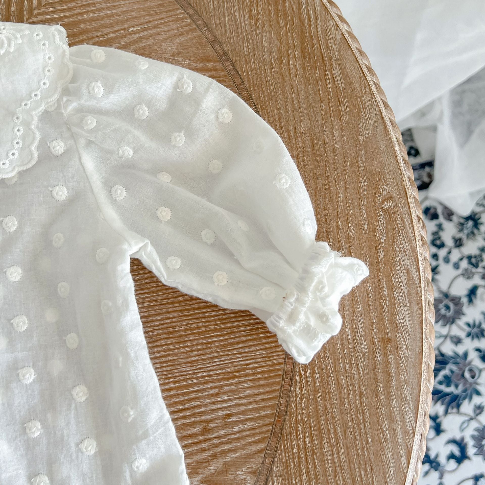 Baby girl wearing a solid color doll neck shirt and shorts set in white and green, showcasing a stylish and comfortable outfit.